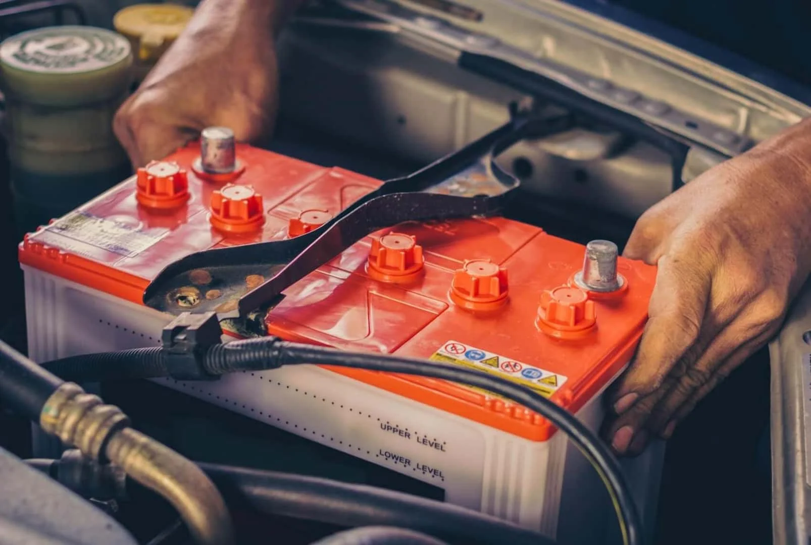 Technician replacing a car battery