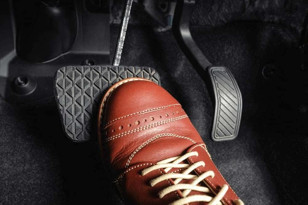 Foot pressing the brake pedal in a BMW