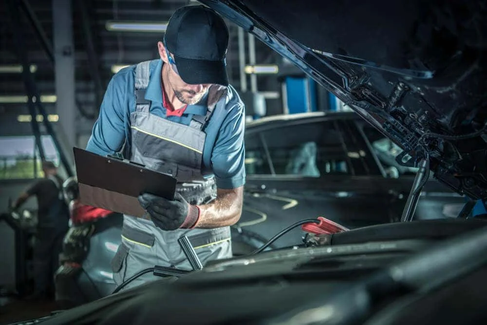 BMW technician performing maintenance service