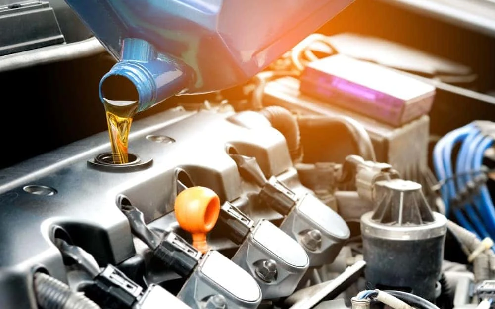 Technician performing an oil change on a BMW
