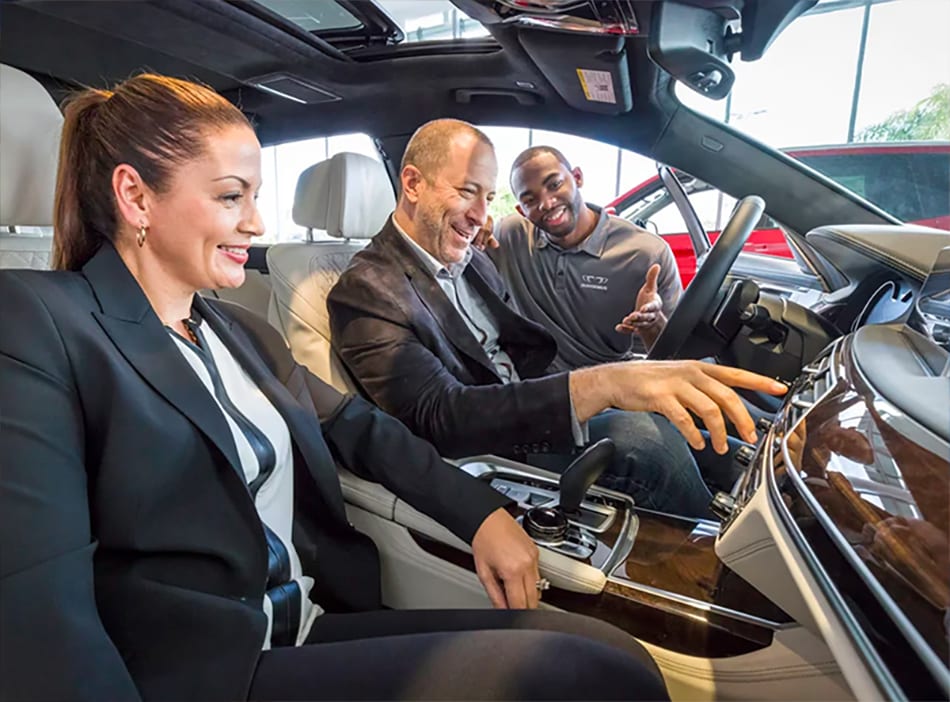 A BMW Genius worker showing the interior of a BMW